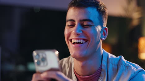man smiling while using phone