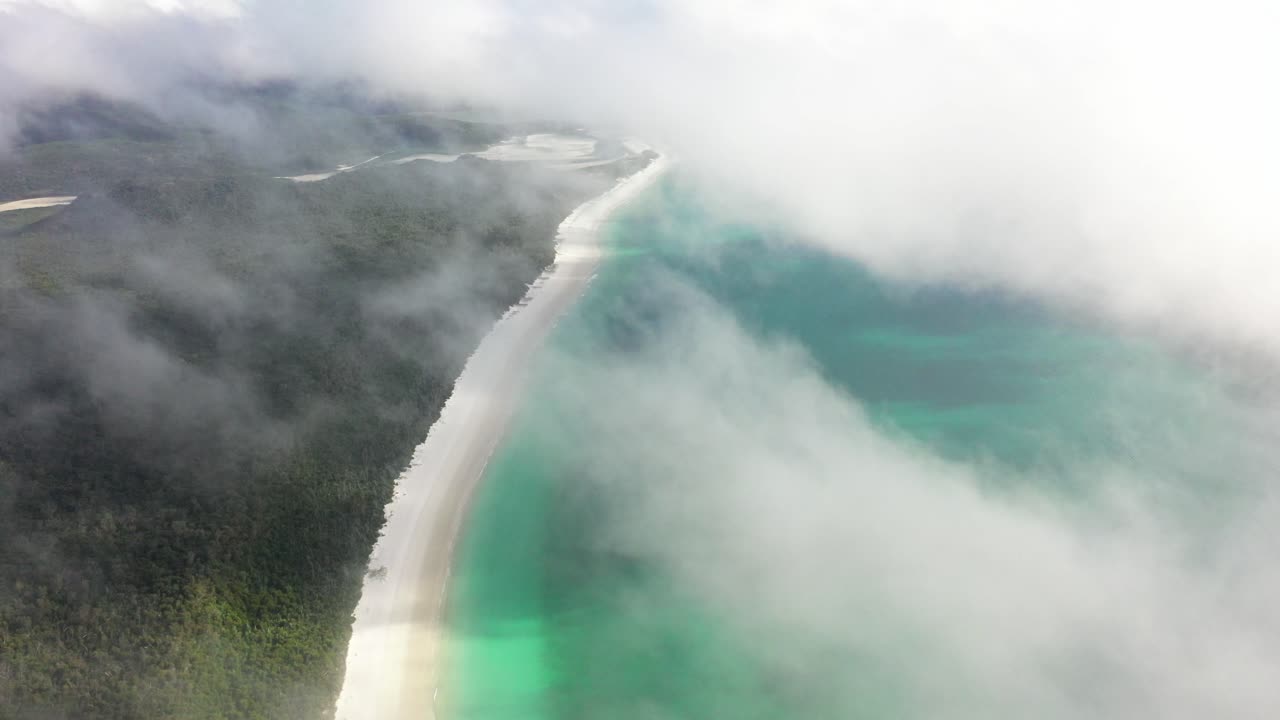Peaceful morning beach aerial in low cloud, QLD Australia coast