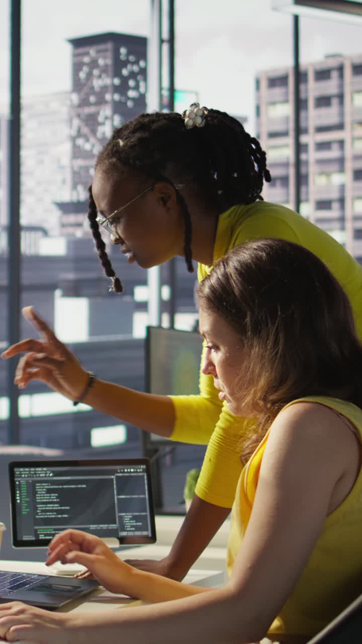 Vertical video Woman and colleague monitoring AI company systems using computer