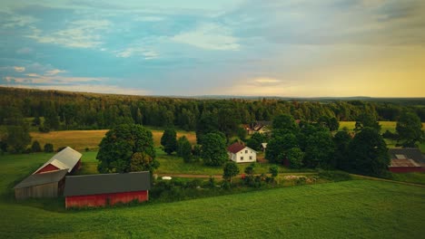 Vista-Panorámica-De-Casas-En-Campos-Verdes-Con-Vegetación-Exuberante-Y-Hermoso-Cielo-Cerca-De-Hjo,-Suecia---Toma-Aérea-De-Drones