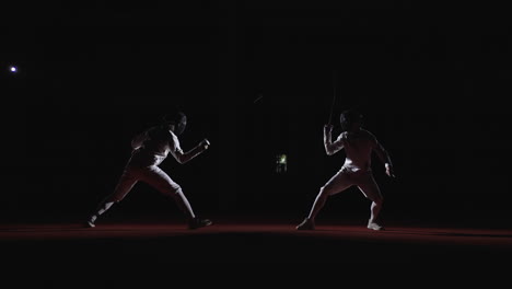 two fencers compete in a match