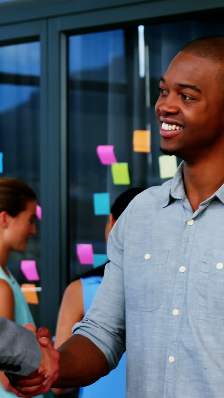 Business executives shaking hands with each other