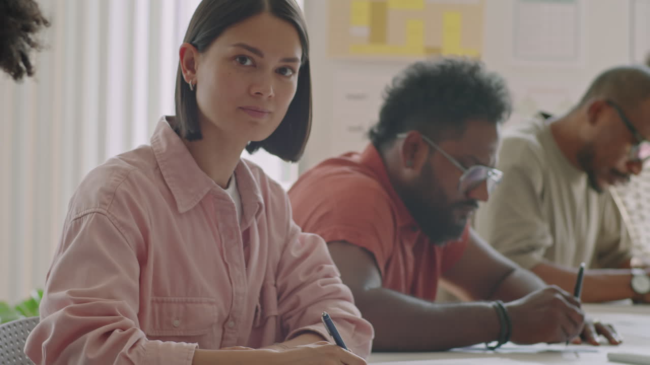 Portrait of Young Woman Studying in School for Migrants