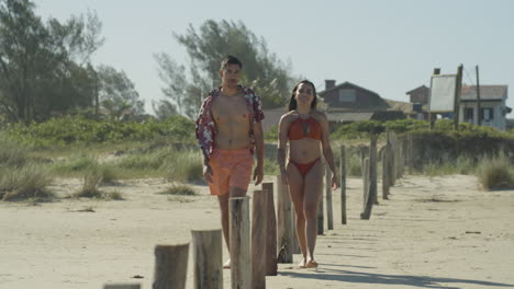 cute couple walking at the beach