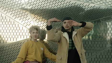 Young-Man-and-Woman-Dancing-Vogue-and-Looking-at-Camera