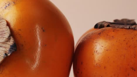 close up of two persimmons