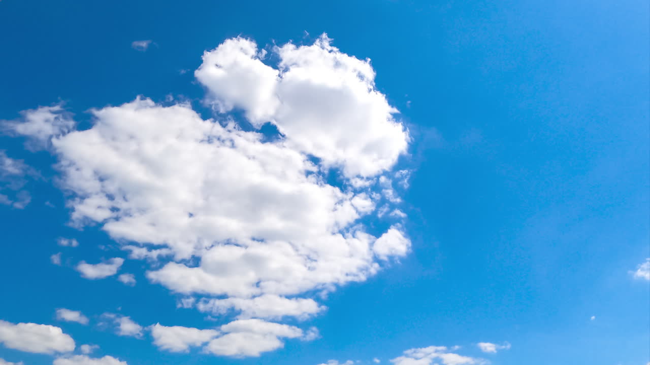 Light blue sky with appearing clouds. Transforming cloudscape timelapse on sunny day.
