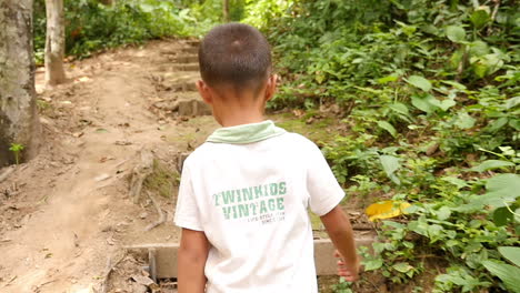 boy walking in a forest
