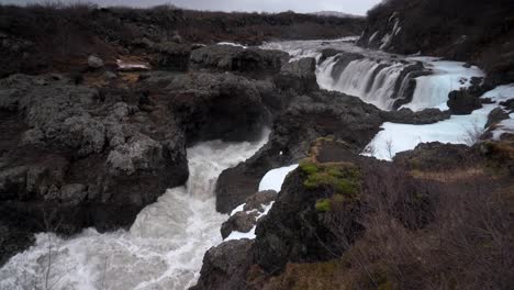 zoom out from scenic cascading barnafoss waterfall in iceland