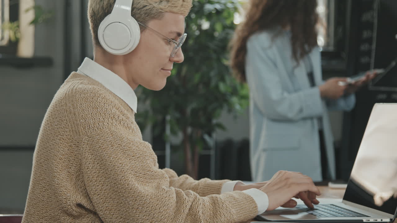 Young Woman in Headphones at Coworking Office