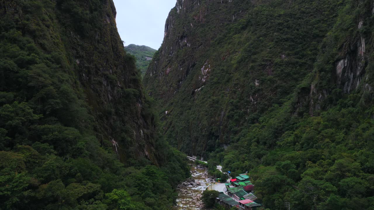 Aguas Calientes Machu Picchu dry rainy season cloudy afternoon Peru aerial drone Peruvian Andes Mountains Urabumba river jungle lower highlands Inca trail citadel landscape buildings circle right