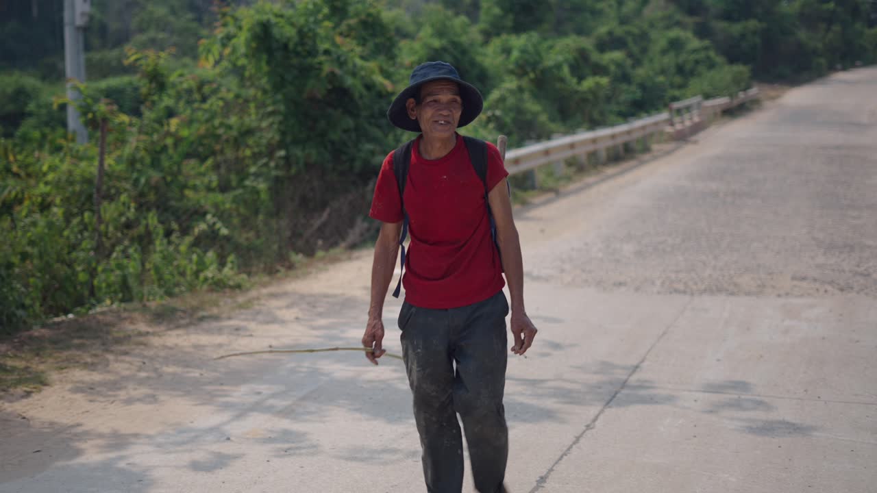 Elderly Man Walking on a Country Road