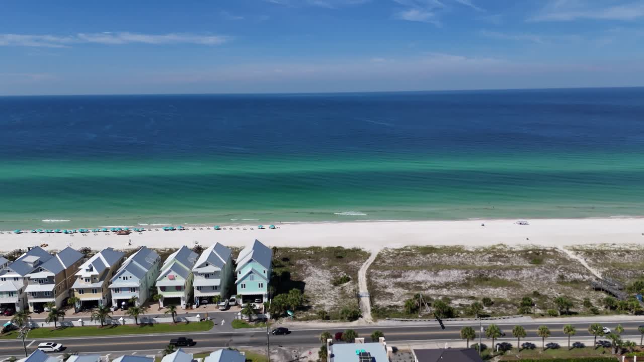 Row of beachfront townhouses with white sandy beach line and turquoise sea, Panama City Beach, Florida, USA