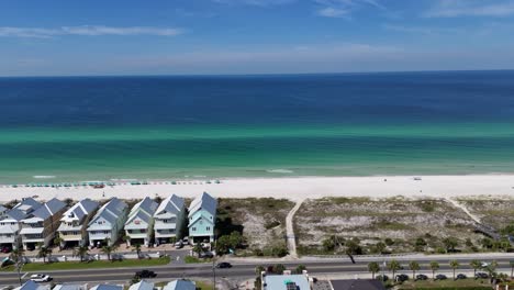 row of beachfront townhouses with white sandy beach line and turquoise sea, panama city beach, florida, usa