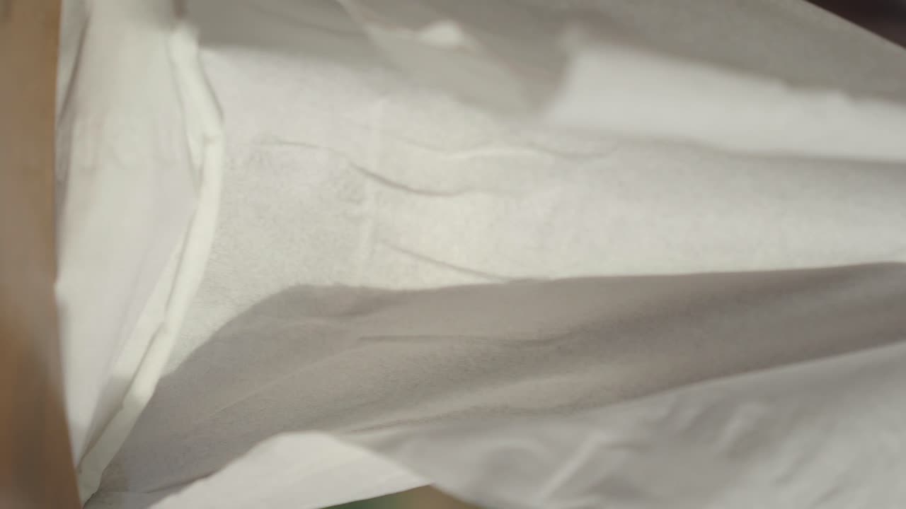 Close-up view of tissue paper being folded
