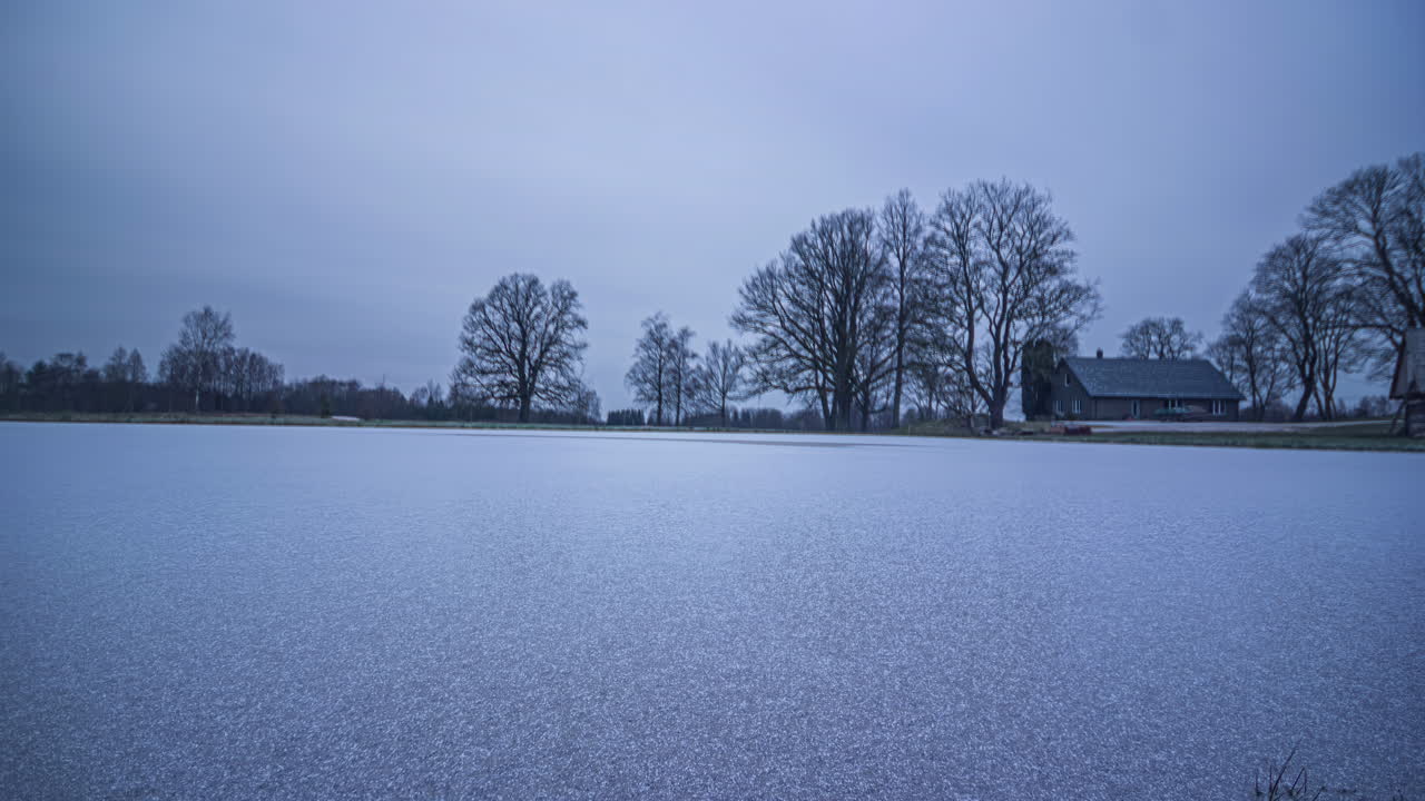 Time-lapse of a European countryside landscape transforming through winter snow, spring blooms, summer greenery, and autumn colors
