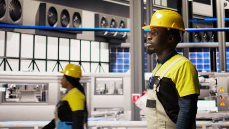 vertical video man holding toolbox walking in factory, inspecting systems
