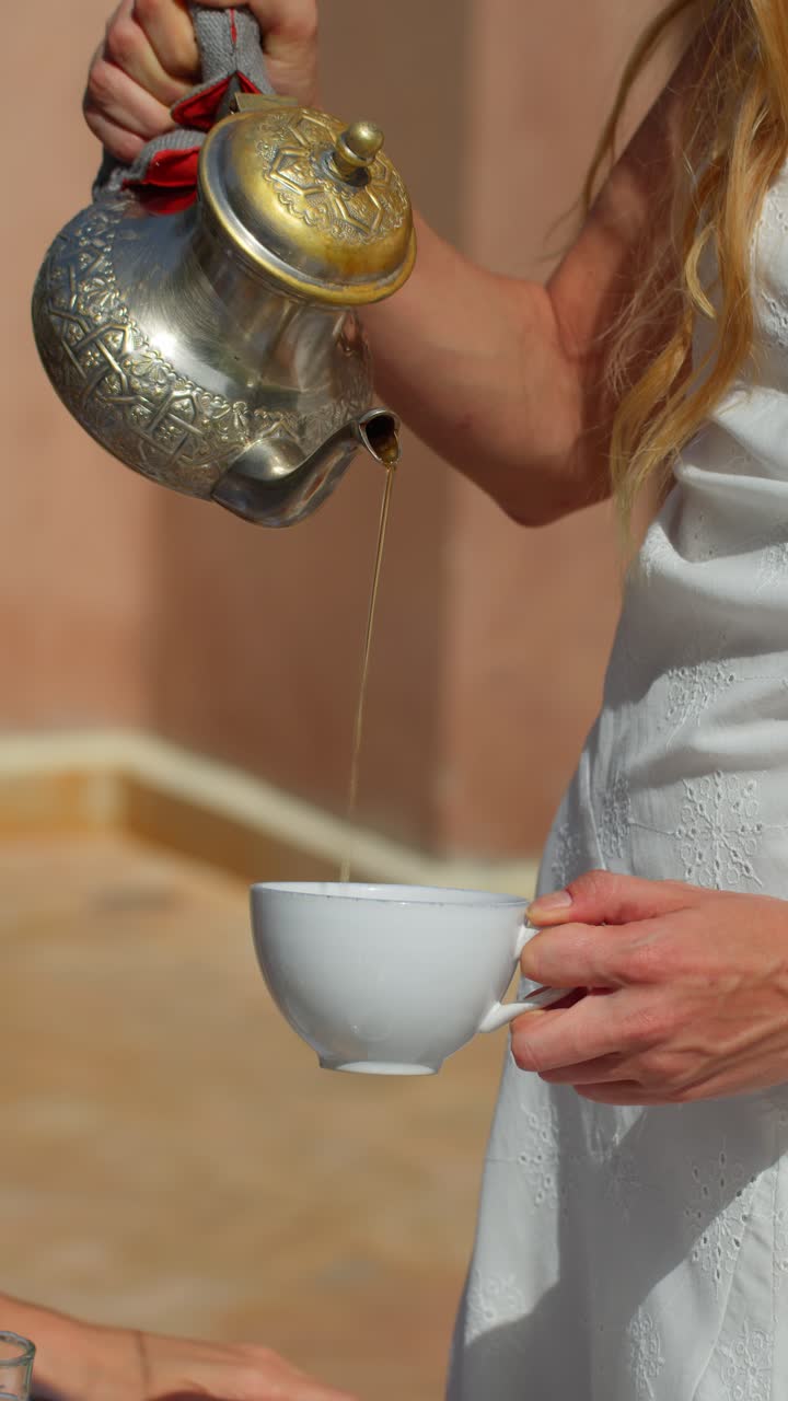 Pouring tea in Marrakesh, showing tradition and elegance