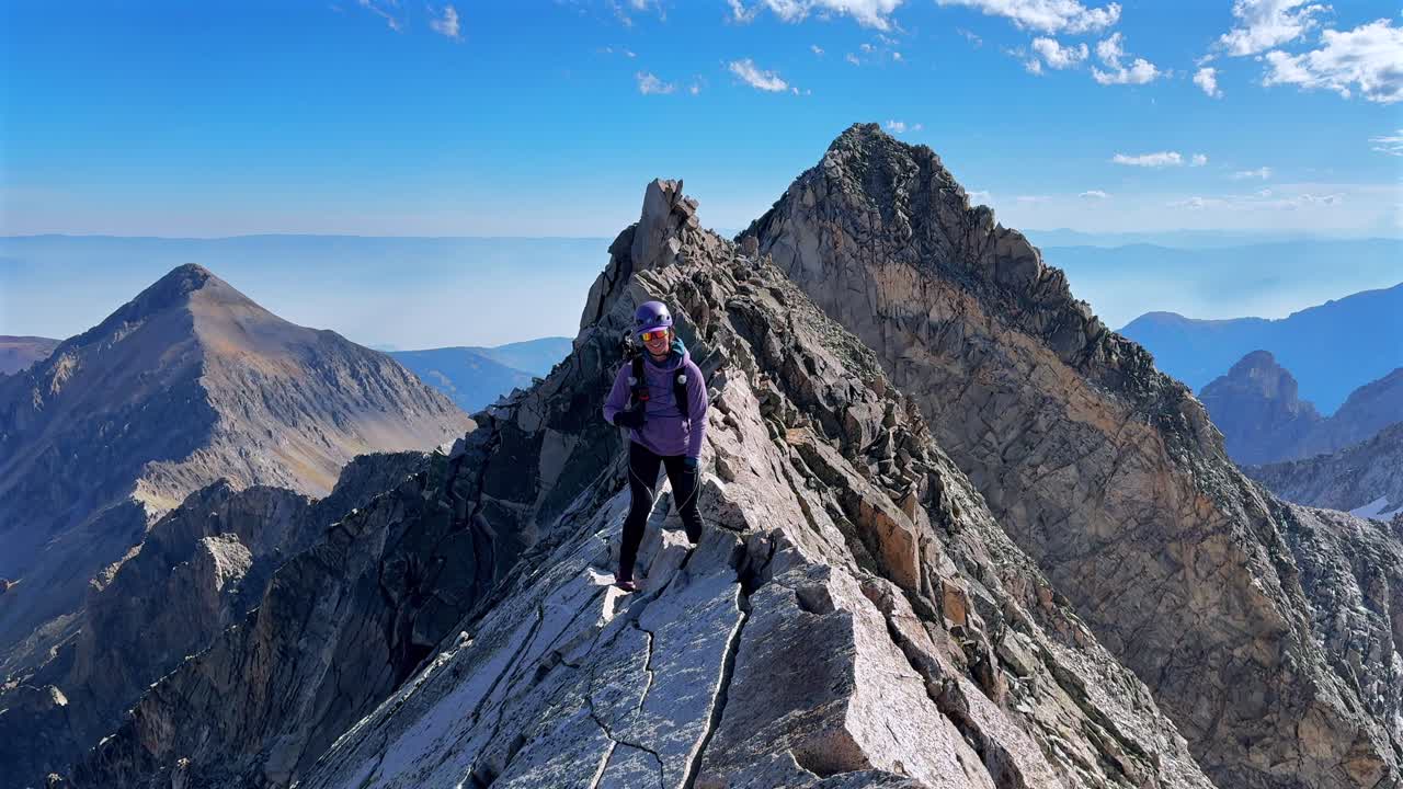 Prominent Rocky Mountains Capitol Peak walking hiking climbing Knifes Edge North East Ridge Trail scrambling Colorado fourtneer rugged terrain summer blue sky morning sunny scenic panoramic landscape