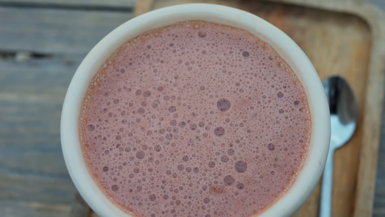 Primo piano di una tazza di cioccolata calda su un vassoio di legno in una terrazza
