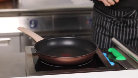 chef pouring oil into a pan