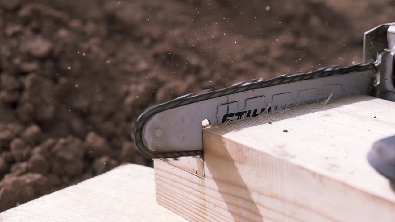 Chainsaw Cutting Wood Beam