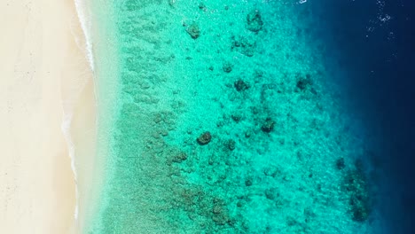 Amazing-colorful-shore-of-tropical-island-with-white-sand,-turquoise-lagoon-with-clear-emerald-water-and-deep-blue-sea-in-Seychelles