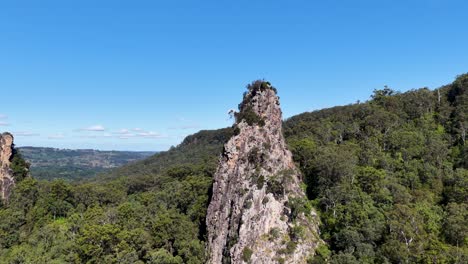 aerial footage of nimbin rocks under clear blue skies, showcasing natural rock formations and lush greenery