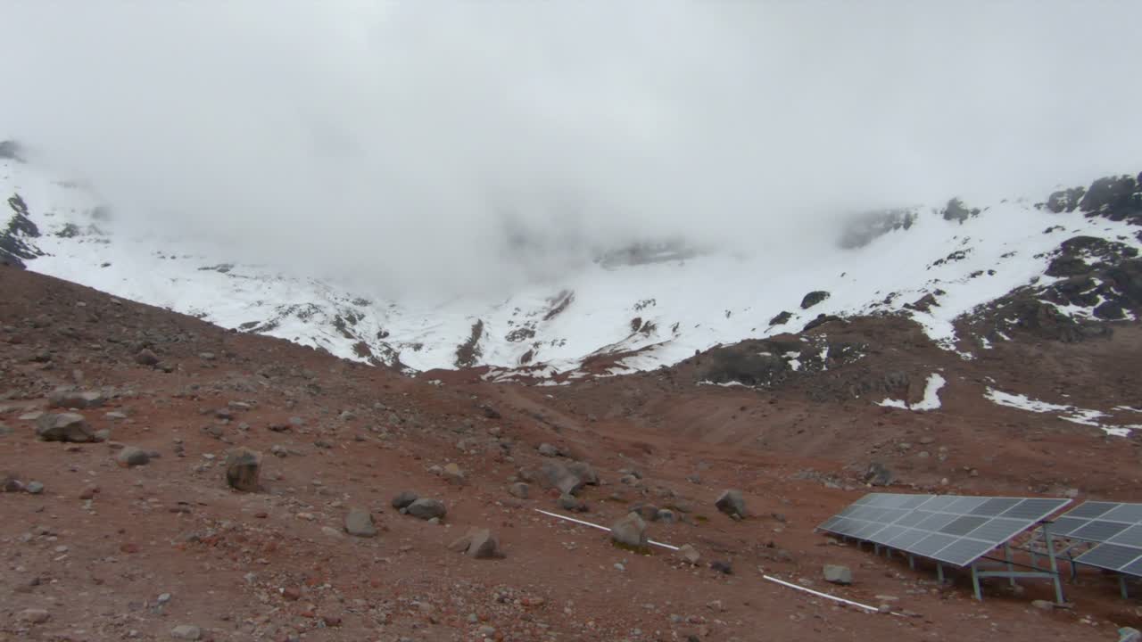 Base of Chimborazo mountain volcano snow fog covered Ecuador nature landscape, refuge solar panels
