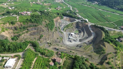 aerial drone footage rotating smoothly from left to right above the basalt quarry in montecchia di crosara, verona, italy