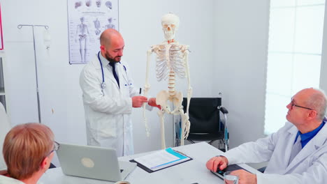 expert doctor in radiology pointing at human skeleton