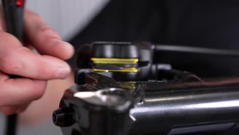 hand removing brake pad spacer from disc brake on a bicycle