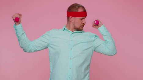 young adult man making fitness exercises with dumbbells alone, working out pumping up arm muscles