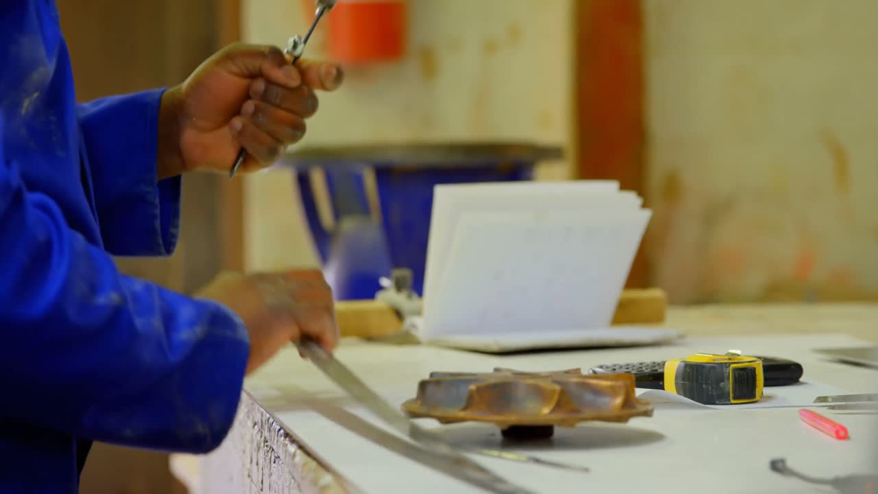 Worker working at table in workshop 4k