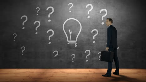 Businessman-looking-at-question-marks-and-bulb