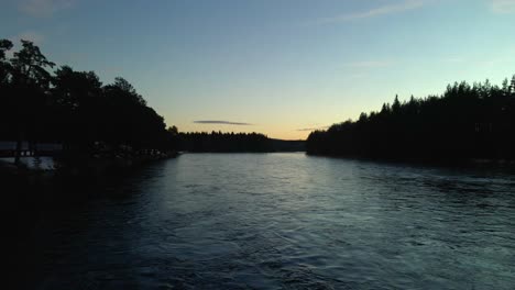 middle of river during dusk, evening, sunset yellow sky, aerial