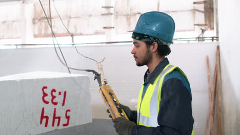 man lifting marble piece