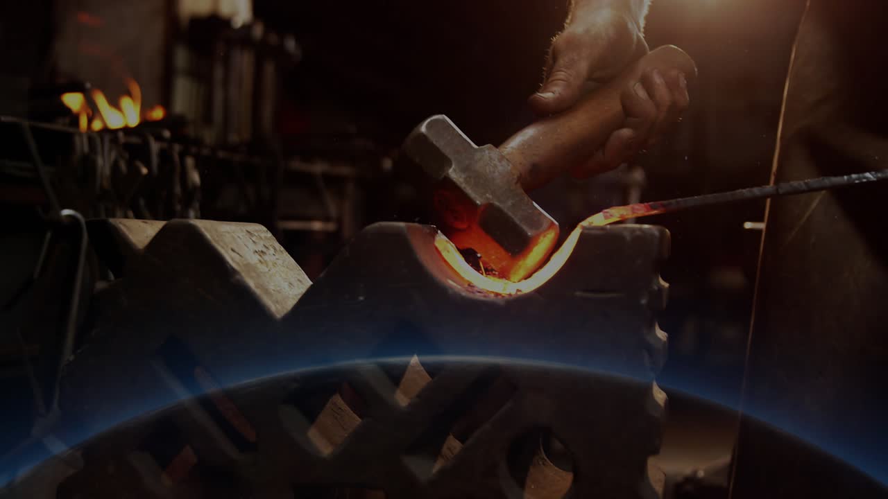 Hammer dropping, worker striking hot U shape metal, shaping inner curve as blue overlay appears