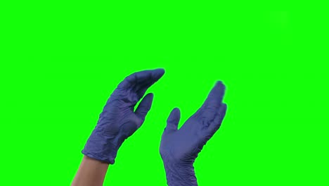 doctors female hands in blue gloves are dancing, gesticulating. green screen. close up