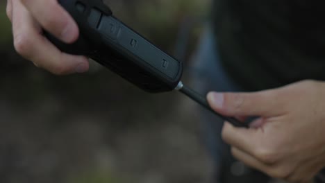 man attaching the insta360 camera on unicorn carbon fiber helmet mount. - closeup shot