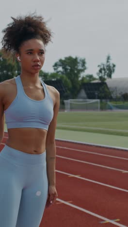 woman athlete getting ready to run on a track