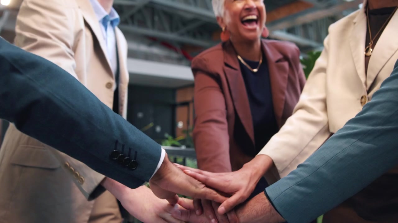 Diverse Business Team Stacking Hands in Office