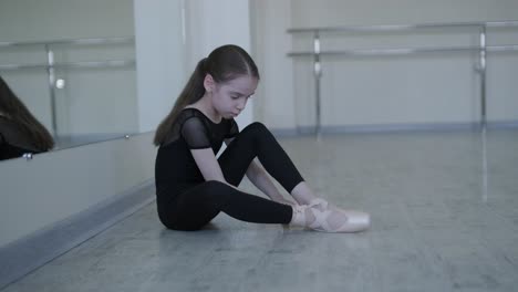 young ballerina practicing dance moves in studio