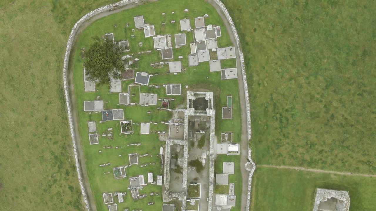Ancient monastery ruins and surrounding cemetery on the hill of slane in ireland, aerial view