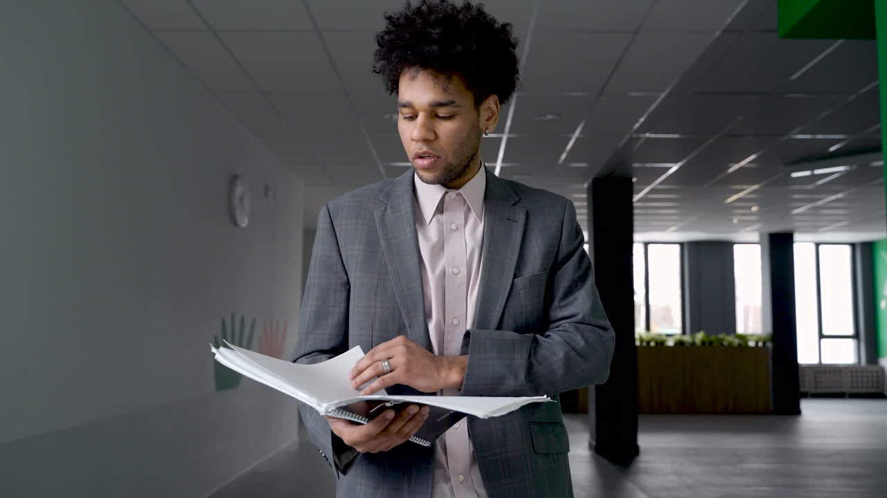 Teacher Flicking Through A Notebook And Smiling