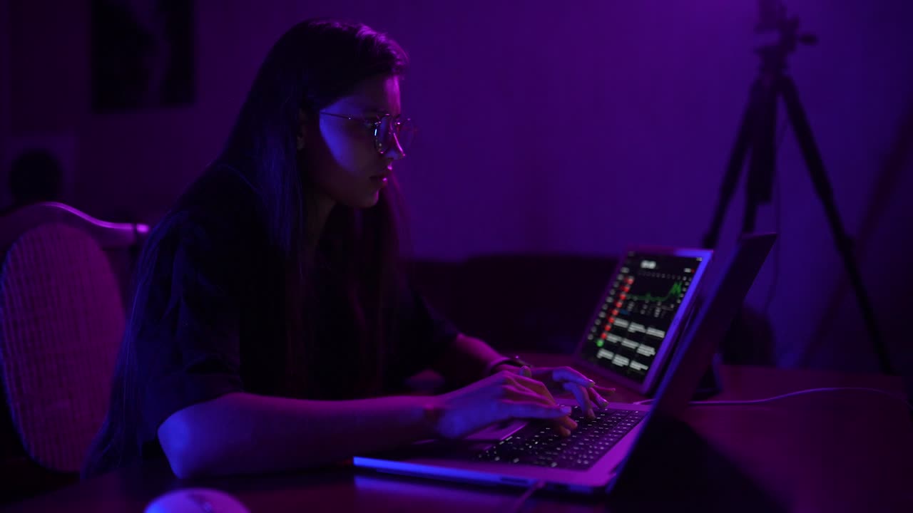Young woman working on laptop at night