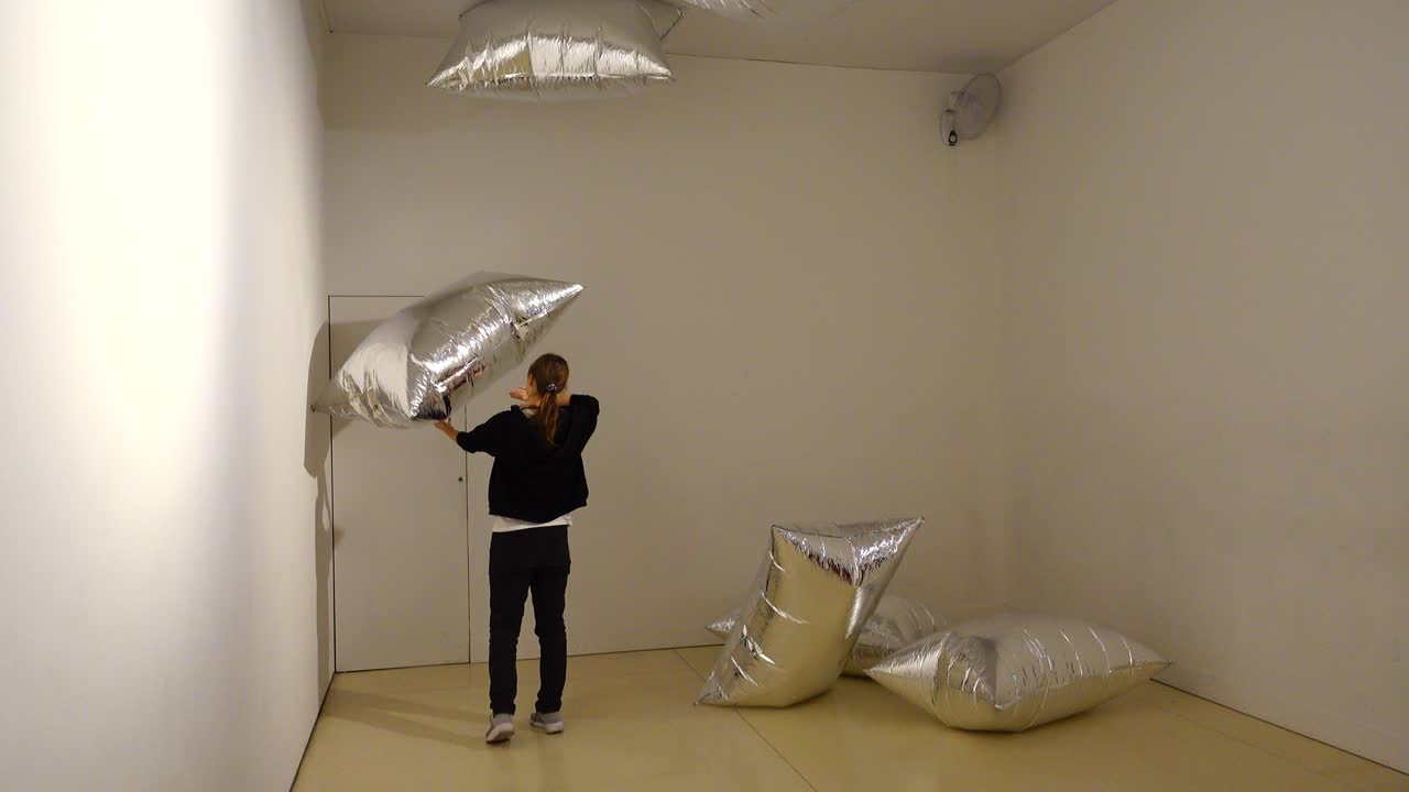 Exibition Andy Warhol "Warhol. Mechanical Art." Madrid. A girl playing with "silver clouds" in the CaixaForum