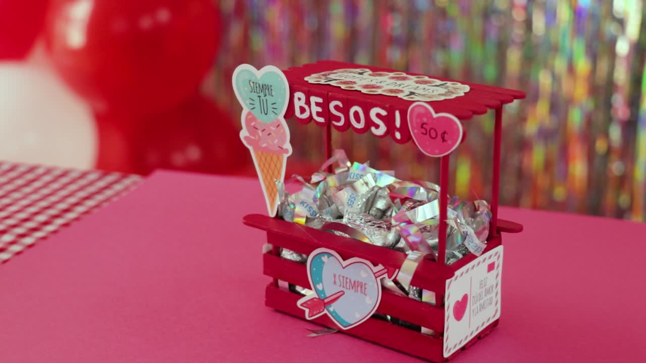 Handmade kissing booth miniature in Valentine's day decoration setting.