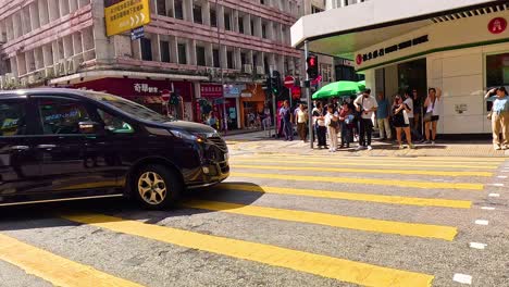 vehicles and pedestrians at a bustling intersection