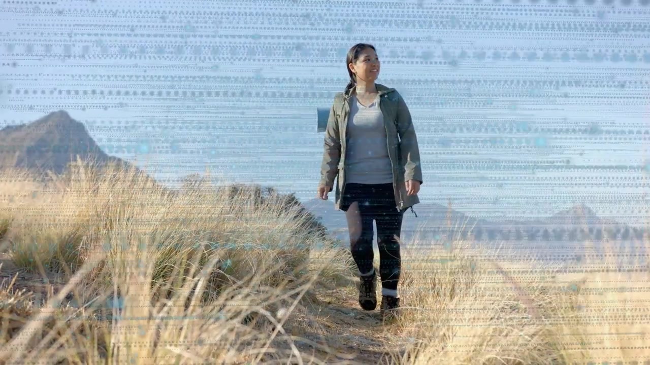 On start hiker walking toward camera, scanning horizon, travel backpack rolled mat, banding overlay
